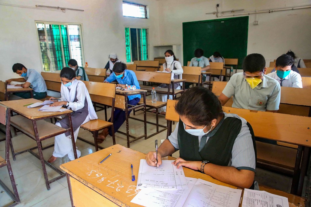 Bhopal: Students wearing protective masks appear in the higher secondary school examinations of Madhya Pradesh Board of Secondary Education, during the fifth phase of ongoing COVID-19 lockdown, in Bhopal, Tuesday, June 9, 2020. (PTI Photo) (PTI09-06-2020_000030B)