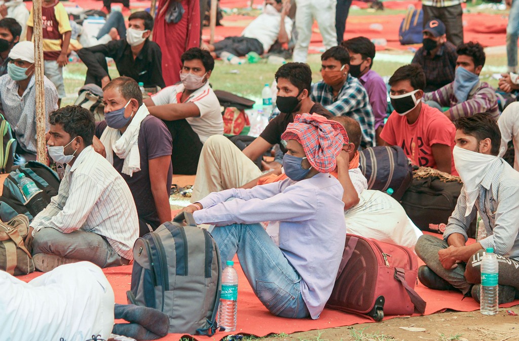 Gurugram: Migrants wait to board a bus for Bihar at Tau Devi Lal Stadium, during the ongoing COVID-19 lockdown, in Gurugram, Tuesday, June 2, 2020. (PTI Photo)(PTI02-06-2020_000216B)