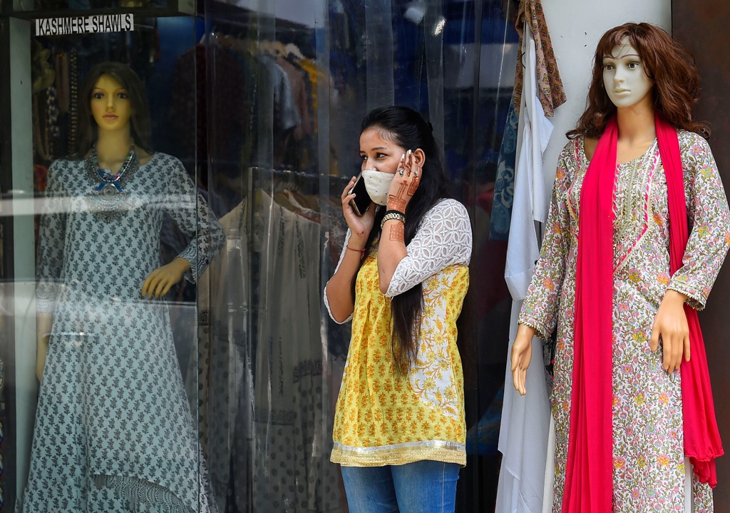 New Delhi: A young woman stands outside a shop at Khan Market during Unlock 2.0, in New Delhi, Thursday, July 2, 2020. (PTI Photo/Kamal Singh)(PTI02-07-2020 000078B)