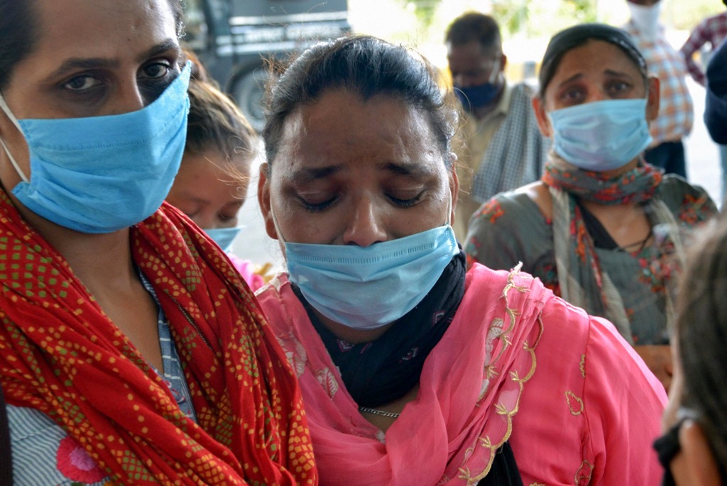 Amritsar: A relative reacts as she waits for the arrival of her family member, who was deported from Malaysia and subsequently stranded due to coronavirus pandemic, at Guru Ram Das Ji International Airport in Amritsar,Saturday, July 11, 2020. (PTI Photo)(PTI11-07-2020 000195B)