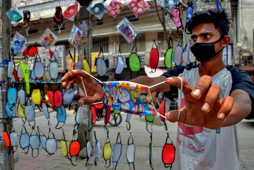 Amritsar: A salesman shows a designer face mask at his roadside stall, during Unlcok 2.0, in Amritsar, Saturday, July 18, 2020. (PTI Photo)(PTI18-07-2020 000066B)