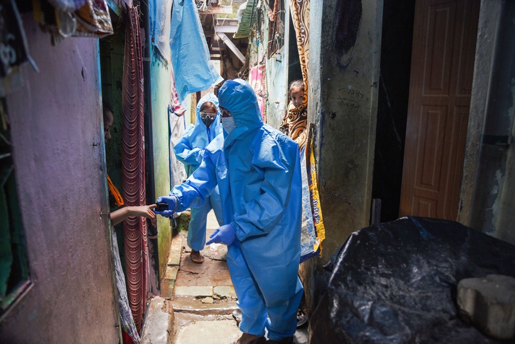 Mumbai: Health workers wearing PPE suits arrive to conduct screening of the residents in a COVID-19 containment zone at Malad in Mumbai, Sunday, July 12, 2020. (PTI Photo)