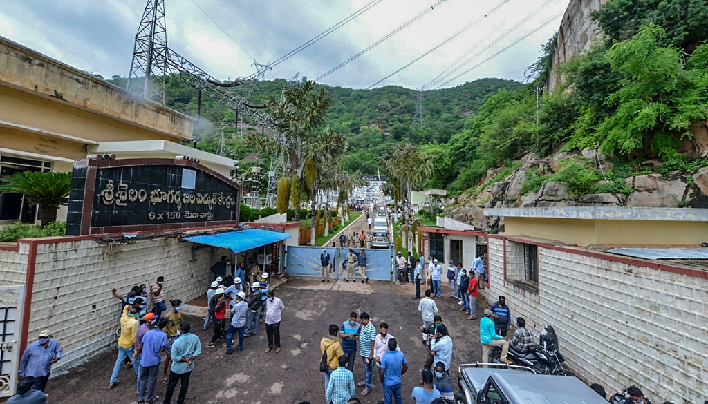 Kurnool: Police and locals gather outside Srisailam Left Bank Power Station (SLBP) after a fire broke out on Thursday night, at Srisailam in Kurnool district, Friday, Aug. 21, 2020. (PTI Photo)(PTI21-08-2020 000104B)