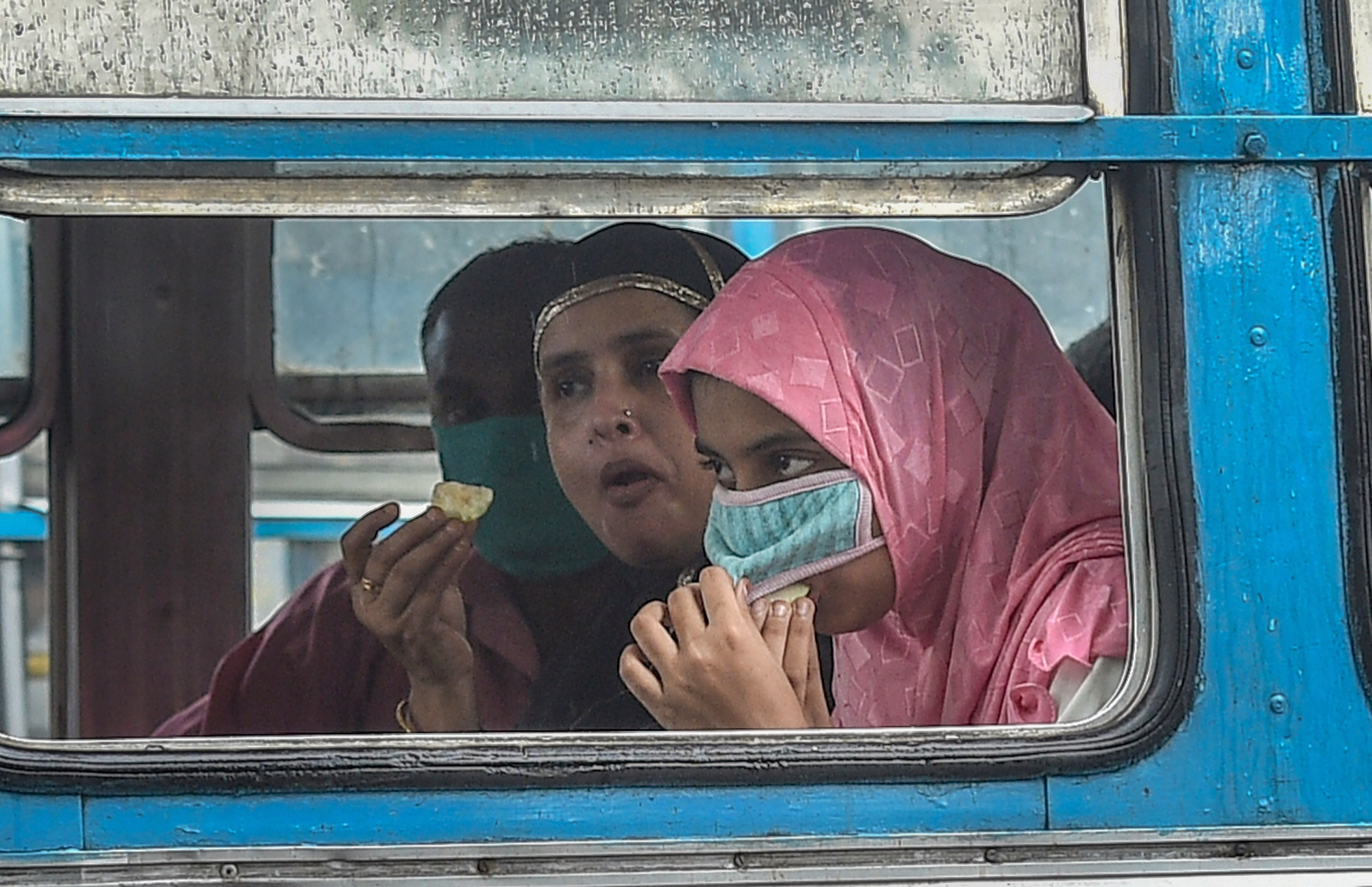 Kolkata: A passenger lifts her face mask to eat food in a bus, during Unlock 4.0, in Kolkata, Wednesday, Sep 2, 2020. (PTI Photo/Ashok Bhaumik)(PTI02-09-2020_000108B)