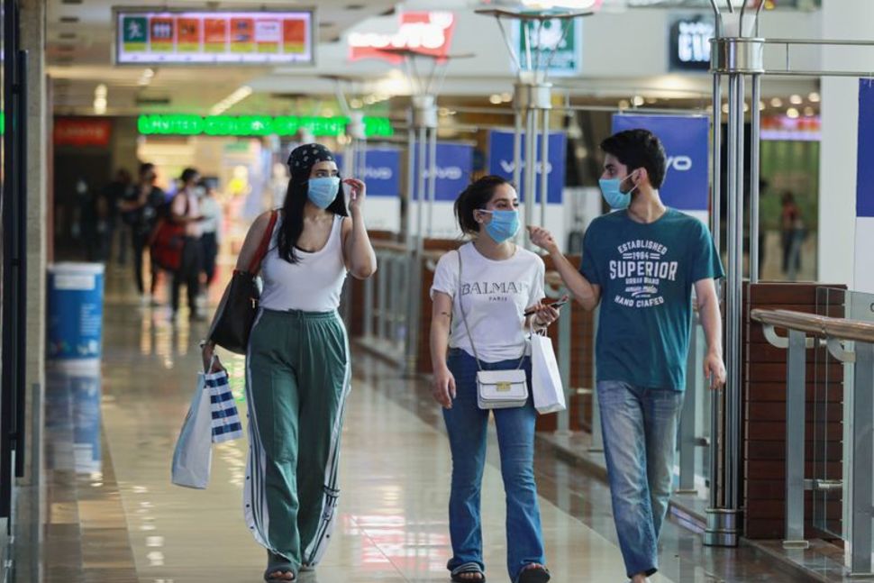 People wearing masks walk with shopping bags inside a mall as India eases lockdown restrictions that were imposed to slow the spread of the coronavirus disease (COVID-19), in New Delhi, India, June 8, 2020. REUTERS/Anushree FadnavisREUTERS