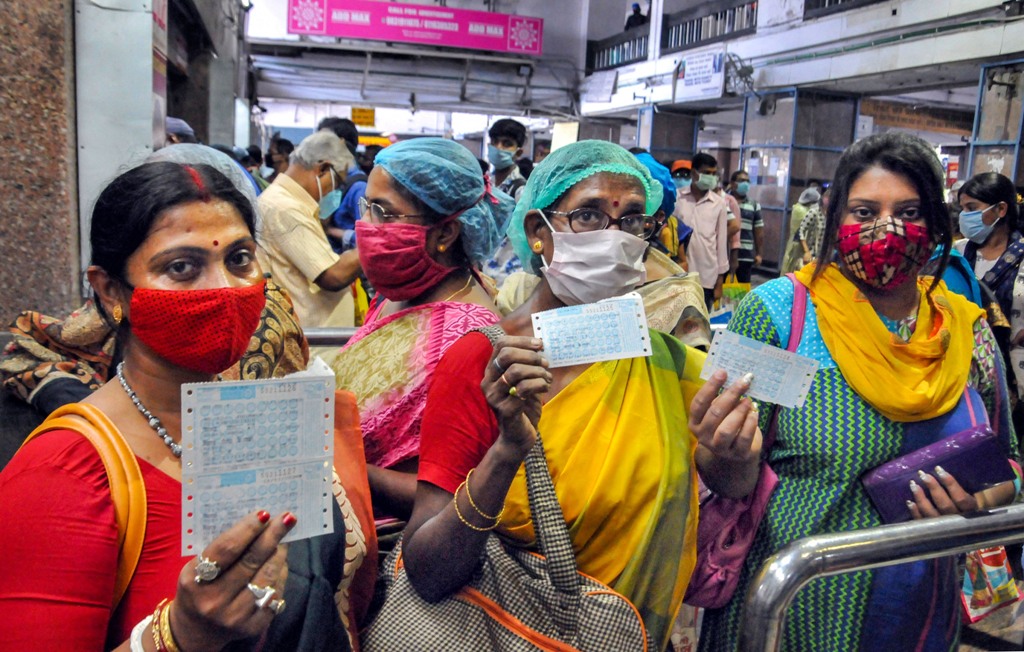 Kolkata: Passengers show their tickets before boarding a local train after the authorities resumed its services from today onwards with certain restrictions, amid the coronavirus pandemic, at Sealdah station in Kolkata, Wednesday, Nov. 11, 2020. (PTI Photo)(PTI11-11-2020 000059B)
