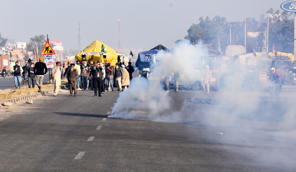 New Delhi: Teargas shells fired by Delhi Police land near protesting farmers to warn them, as they try to cross the border into Delhi during their Delhi Chalo protest against Kisan Bill, at Singhu border in New Delhi, Friday, Nov 27, 2020. (PTI Photo)(PTI27-11-2020 000013B)