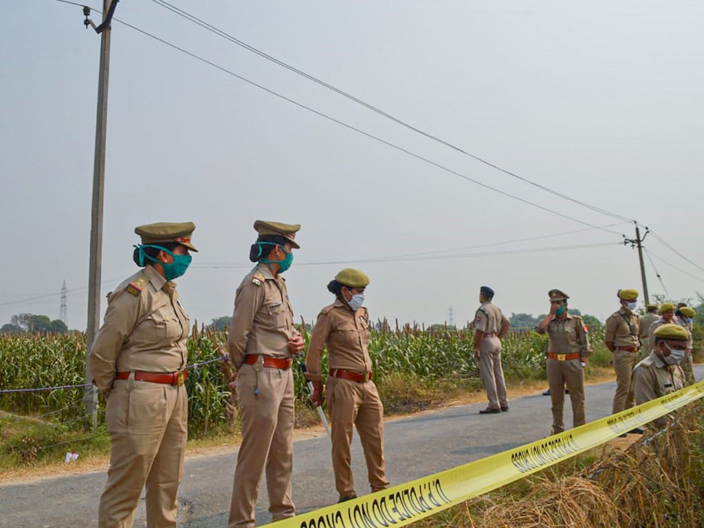 Hathras: Police personnel stand guard as CBI officials (unseen) investigate the case of a 19-year-old Dalit woman who died after being allegedly gang-raped, in Hathras, Tuesday, Oct. 13, 2020. (PTI Photo)(PTI13-10-2020 000190B)