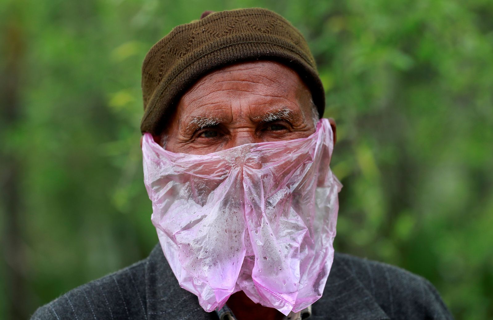 A man uses a plastic bag as a mask amid concerns about the spread of coronavirus disease (COVID-19), in Srinagar April 7, 2020. REUTERS/Danish Ismail     TPX IMAGES OF THE DAY