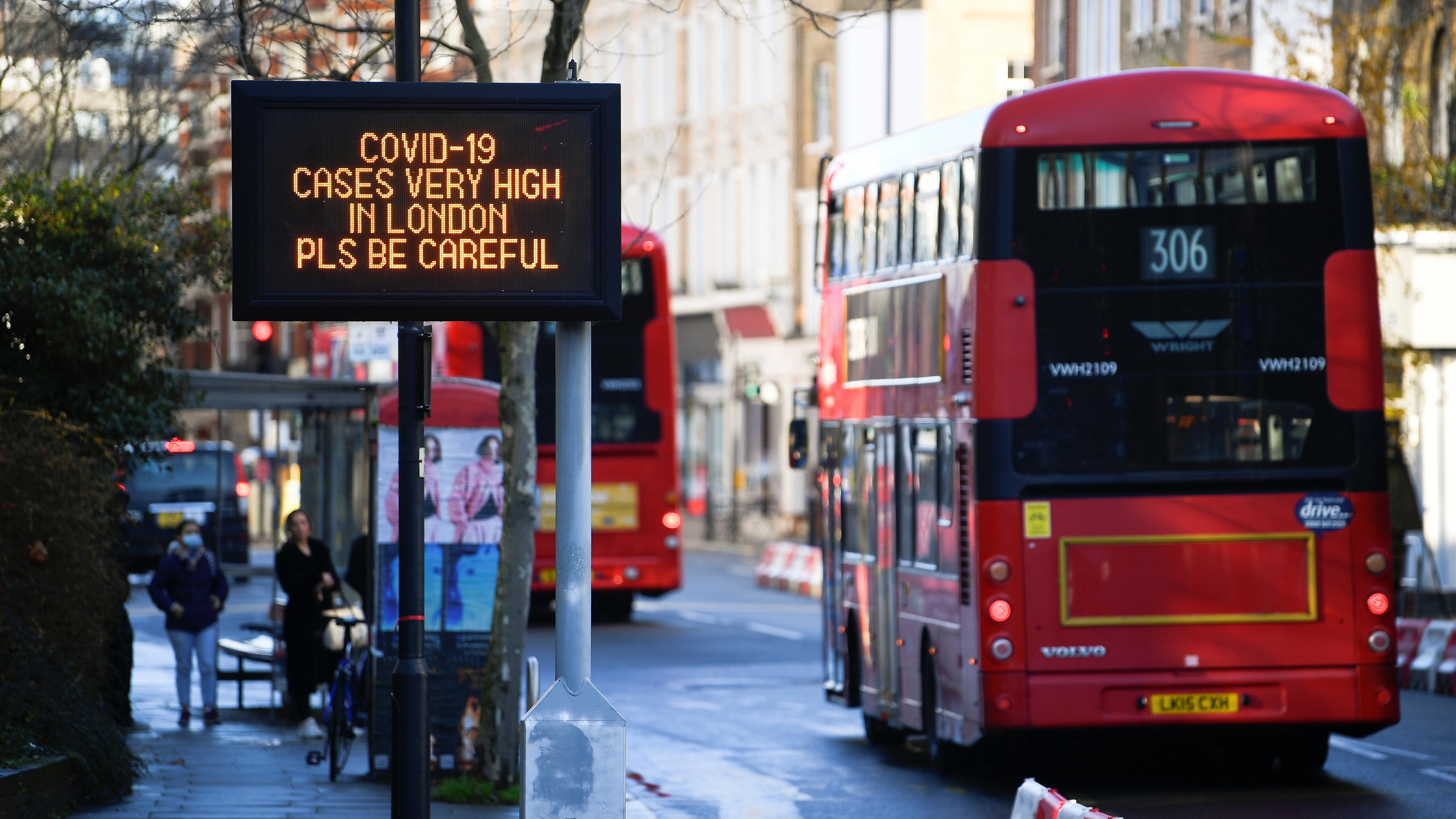 London buses pass a public health information message as new restrictions come into force Photograph: Toby Melville/Reuters