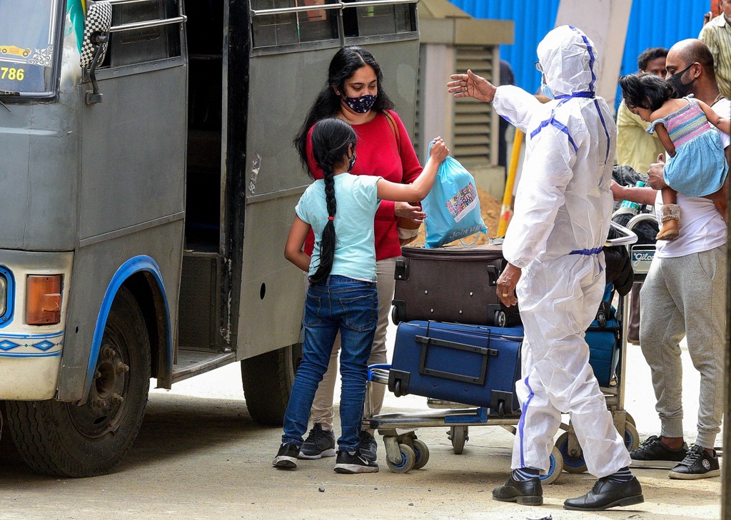 Chennai: A health worker guides passengers to a quarantine centre on their arrival from the United Kingdom, at the Chennai International Airpor, in Chennai, Tuesday, Dec. 22, 2020. Indian government has temporarily suspended all passengers flights from the United Kingdom in the wake the new COVID-19 strain found in the country. (PTI Photo) (PTI22-12-2020 000149B)