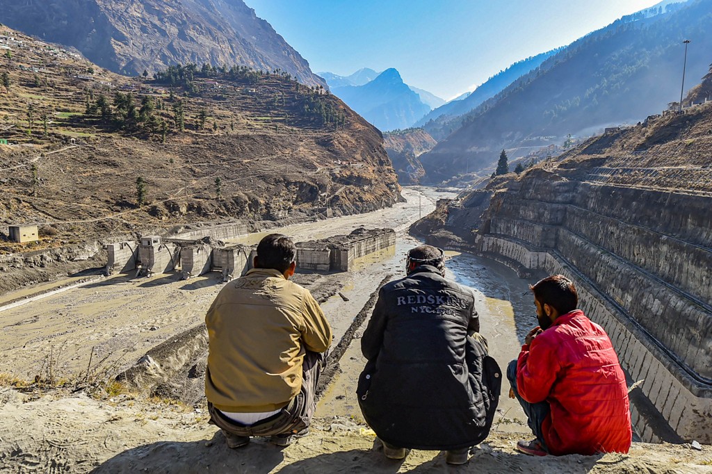 Chamoli: Villagers watch the rescue operations carried at Tapovan barrage, following the Sundays glacier burst in Joshimath causing a massive flood in the Dhauli Ganga river, in Chamoli district of Uttarakhand, Wednesday, Feb. 10, 2021. (PTI Photo/Arun Sharma) (PTI02 10 2021 000065B)