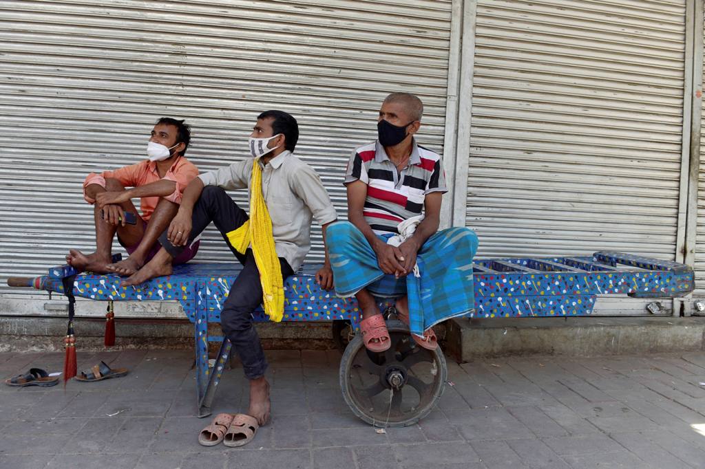 New Delhi: Labourers take rest in a closed market at Khari Baowli, during COVID-19 lockdown in New Delhi, Tuesday, May 25, 2021. (PTI Photo/Vijay Verma)(PTI05 25 2021 000122B) 