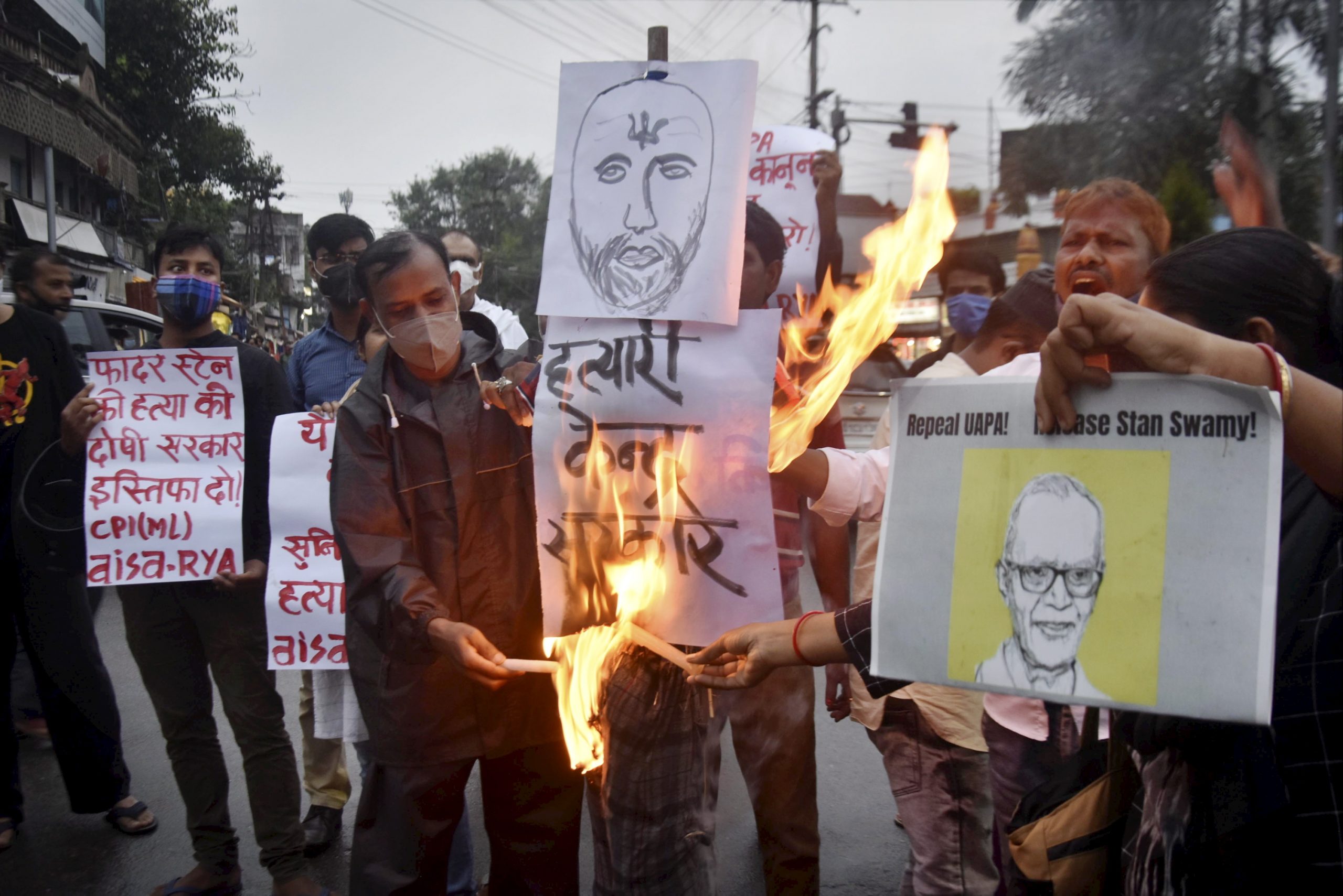 Ranchi: Activists participate in candle light vigil to pay tribute to civil rights activist Father Stan Swami, an accused in the Elgar Parishad-Maoist links case who died at a Mumbai hospital, in Ranchi, Monday, July 5, 2021. (PTI Photo)(PTI07_05_2021_000257B)